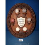 A contemporary display of Golf Balls marked 'The History of The Golf Ball', mounted on oval plaque,