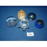 Five paperweights including Caithness 'Pixie' and 'Quattro', Edinburgh Crystal etc.