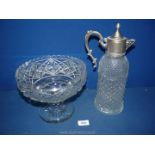 A moulded cut glass claret jug with white metal top plus a footed fruit bowl.