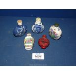 Five smelling salt/perfume bottles including Cinnabar and oriental patterned porcelain.