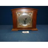 A small wooden framed mantel clock from Oswins & Co, Hereford,