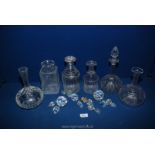 A quantity of cut glass decanters and stoppers