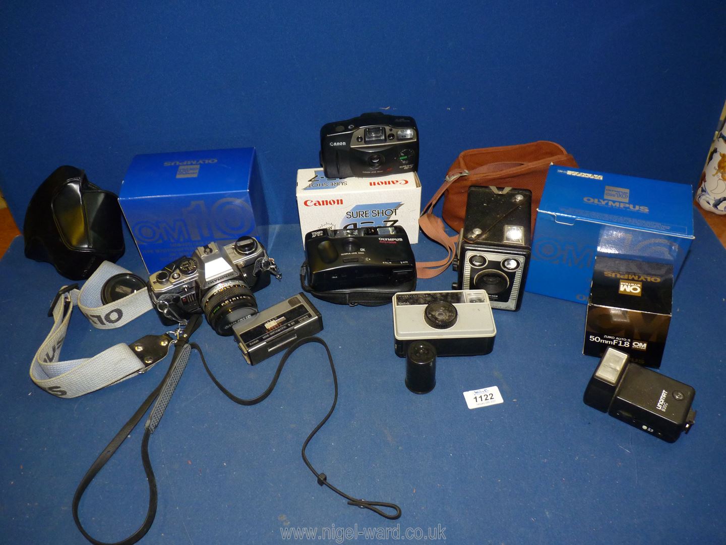 A quantity of cameras including Brownie Six - 20 model C in a case, two boxed Olympus OM ,