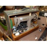 A cased electric Singer Sewing Machine, model no. EK829212.