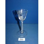 An early, possibly 18th century wine glass with straight air twist stem and etched bowl,