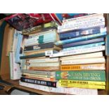 A box of books to include; paperback novels, golf techniques, etc.