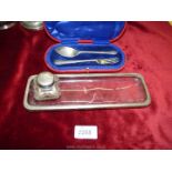 A velvet lined box with Silver spoon/fork, London, a silver topped glass ink pot,