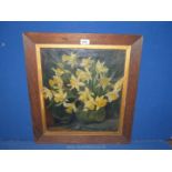 A wooden framed Oil on canvas depicting a glass vase of daffodils, initialled lower right E.A.R.