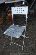 A galvanised folding chair