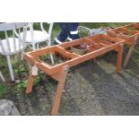 A wooden folding table base