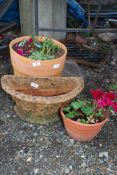 Three terracotta planters of various sizes,