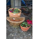 Three terracotta planters of various sizes,