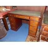 A circa 1900 double pedestal Kneehole writing Desk having three frieze drawers,