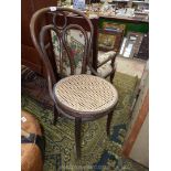 A Bentwood framed French cafe type Chair having a circular caned seat.