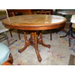 An attractive oval snap top Loo table having lightwood stringing and central oval inlaid detail to