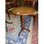 A circular Oak occasional Table standing on turned support with three pirouette feet,