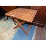 An unusual Teak wood folding Table having pierced top, 19 3/4" x 19 3/4" x 19 5/8" high.