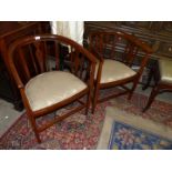 An elegant pair of Edwardian Mahogany bow back Elbow Chairs having lightwood stringing and details,