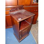 An Edwardian Mahogany bedside Cabinet having a raised and fielded panelled door with an open shelf