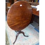 A one plank top Mahogany circular snap-top Table standing on a turned pillar with spirally reeded