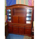 A darkwood lounge unit, the base with three frieze drawers,