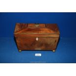 A Mahogany sarcophagus shaped Tea Caddy on ornate brass ball feet,