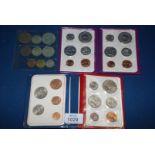 Five UK and Australian coin sets.