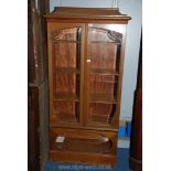 A continental design Satinwood Bookcase having shaped bevelled glazed doors,