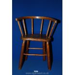 A child's bow back Windsor chair with figured elm seat, turned beech spindle supports and legs,