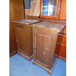 A pair of Oak bedside Cabinets, each having a raised and fielded panelled door,