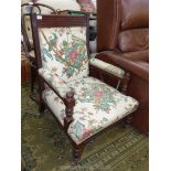 A late Victorian/Edwardian Mahogany framed fireside Armchair having turned front legs and arm