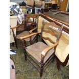 A pair of mixed hardwood framed ladderback open armed Elbow Chairs having woven seagrass seats