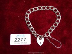 A large link solid silver bracelet with padlock fastening, each link marked.