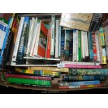 A box of walking and travel books.