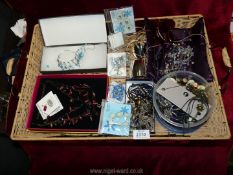 A quantity of Costume Jewellery including beads, bangles, necklaces all on a wicker tray.