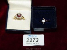 A gold coloured dress ring with red and white stones plus a gold coloured cross over ring with a