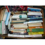 A box of books to include paperback novels, golf techniques etc.