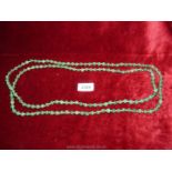 A long strand of Jade beads, 33 1/2'' long.