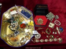 A quantity of costume jewellery to include; brooches, earrings, velvet choker, etc.
