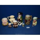 A small quantity of jugs to include two Goebel monk jugs, "Mr Micawber" Avon ware jug,