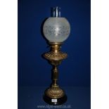 A Victorian brass oil lamp on pillar type column with etched glass shade and chimney, double burner,