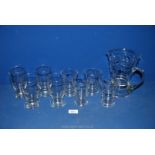 A water jug and four matching glasses, plus four other glasses.