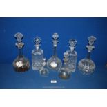 A quantity of glass decanters including two pairs,one square the other globe shaped with long neck,