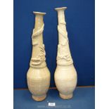 A matched pair of Chinese Celadon glazed Vases with applied dragons curling around the necks,