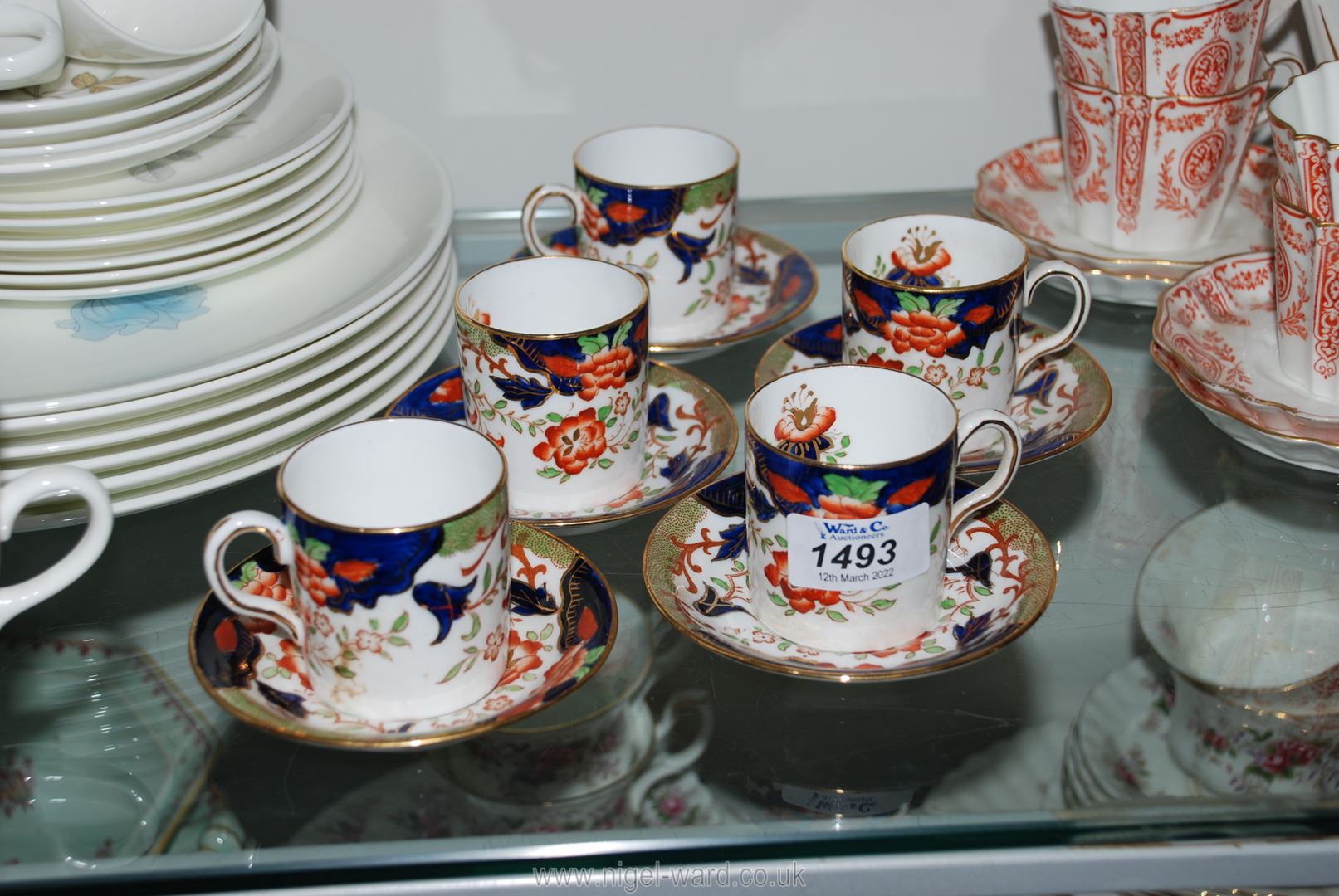 Five Gaudy Welsh style cups and saucers with orange flower and green leaves on blue and white