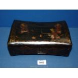 A Chinese lacquered neck rest decorated with oriental drawings of children, 10" x 7" x 4".