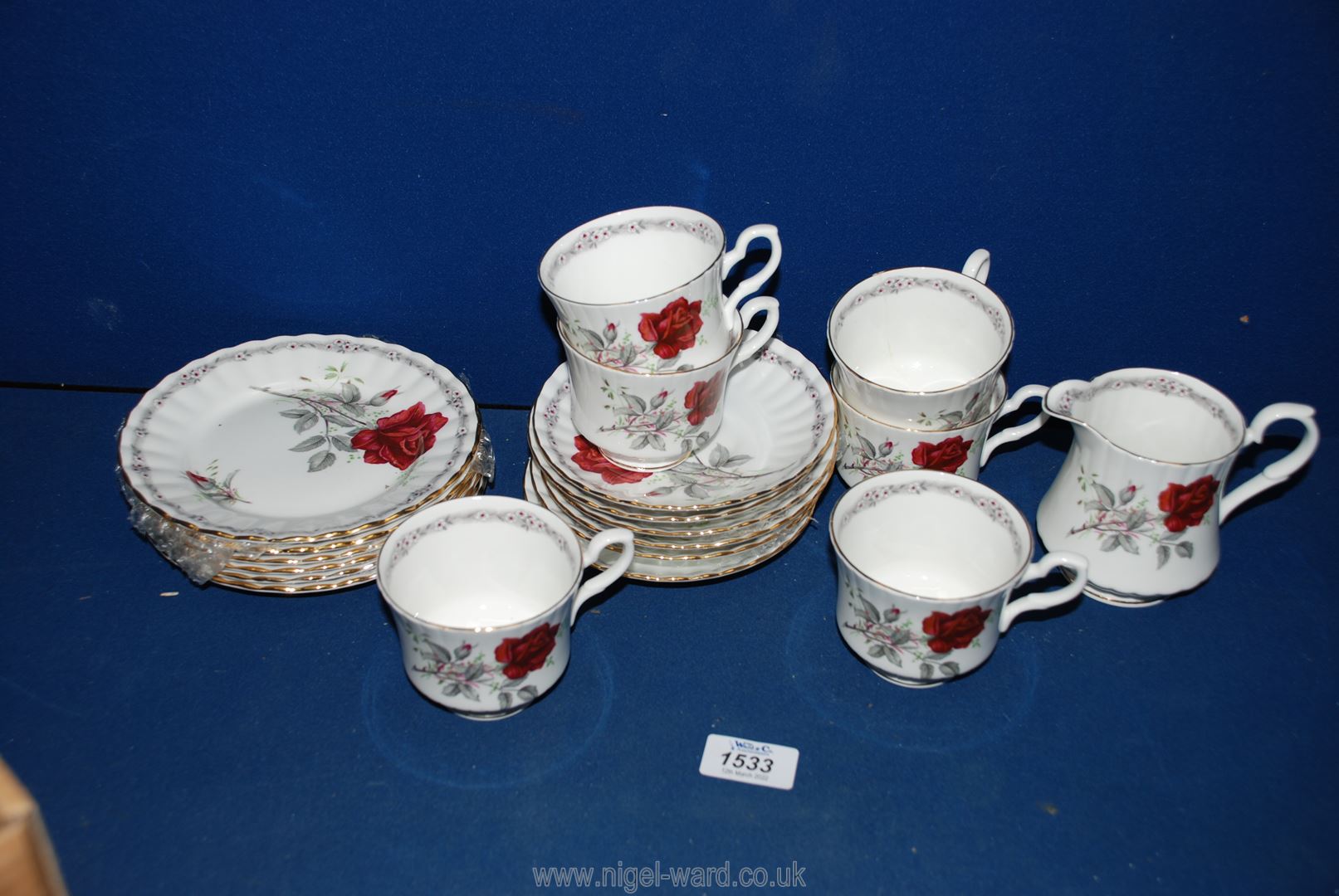 A Royal Stafford Roses part tea set including six cups/saucers/plates and a milk jug (large crack