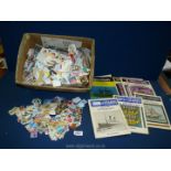 A large quantity of loose stamps and thematic slips on stamps catalogues.