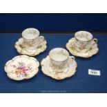 Three Limoges coffee cans and saucers with gold highlighted embossed detail and a Crown Derby