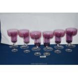 Six pink glass champagne bowls and six matching sherry glasses with fine gilt rims.